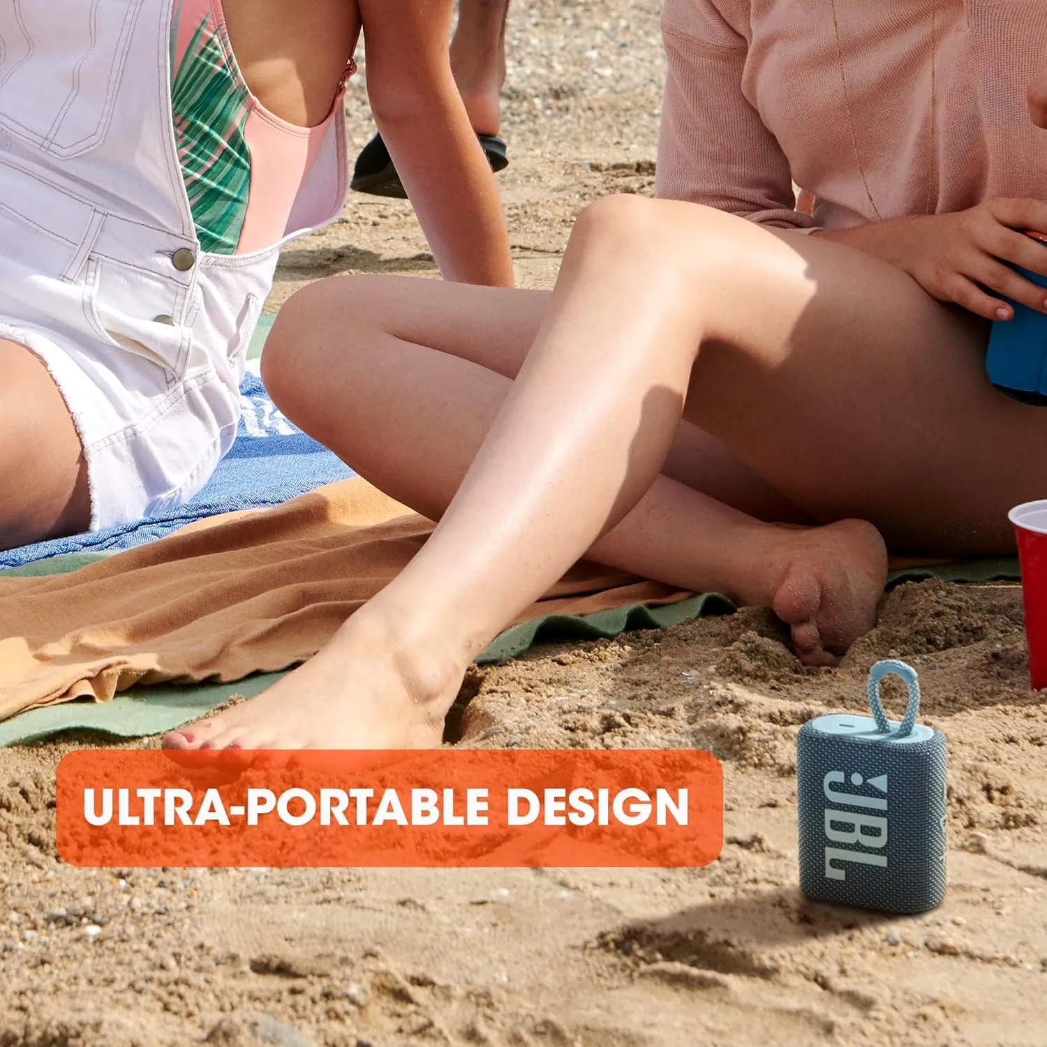 JBL Go 3 mini speaker on beach with ultra portable design text
