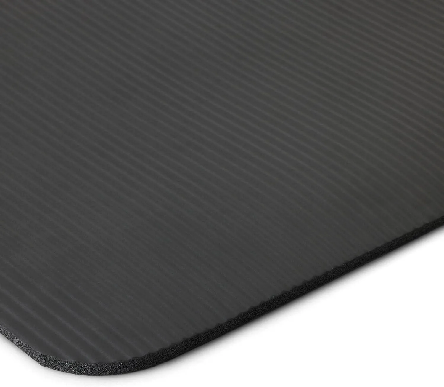 Close view of the black textured exercise mat surface and rounded edge.